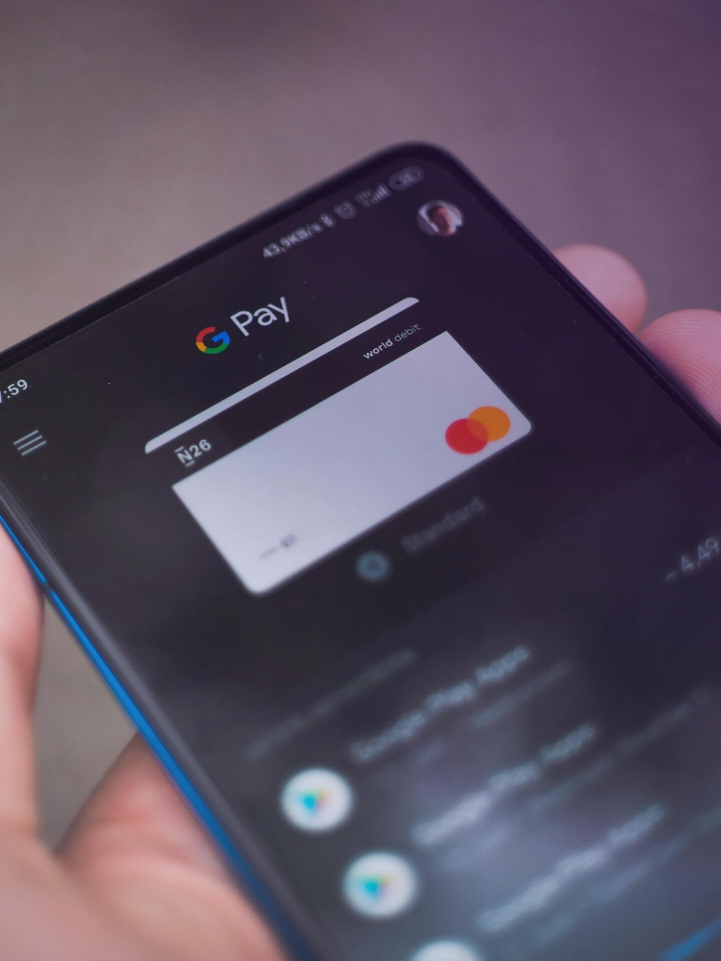 A hand holding a phone that shows an online store's payment screen