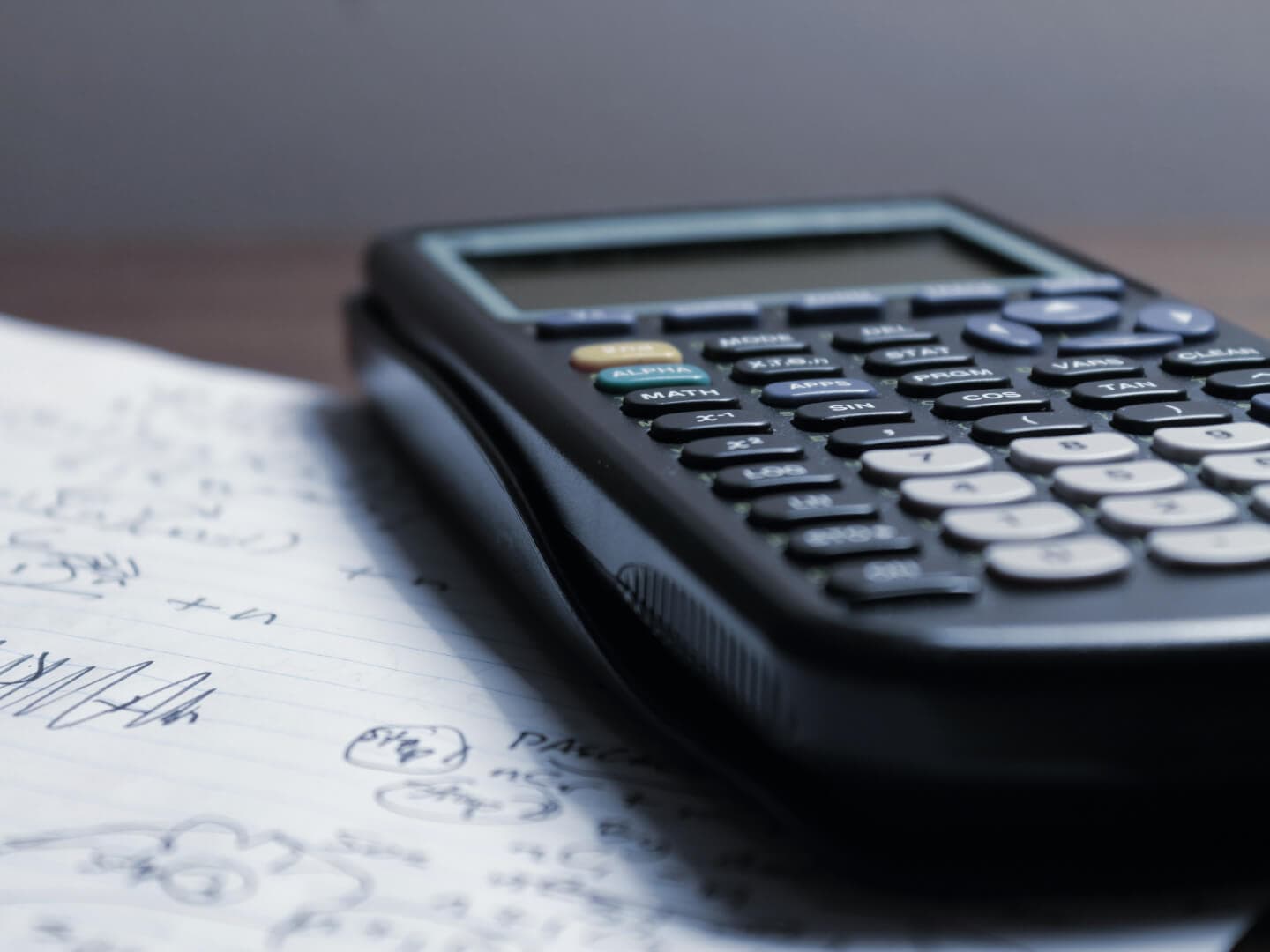 Calculator resting on handwritten notes